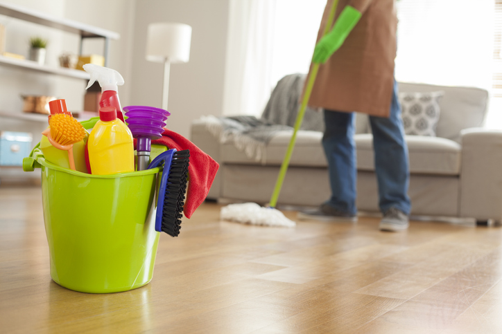A residential professional cleaner cleans and refreshes the outdoor living area as part of the summer home maintenance checklist.